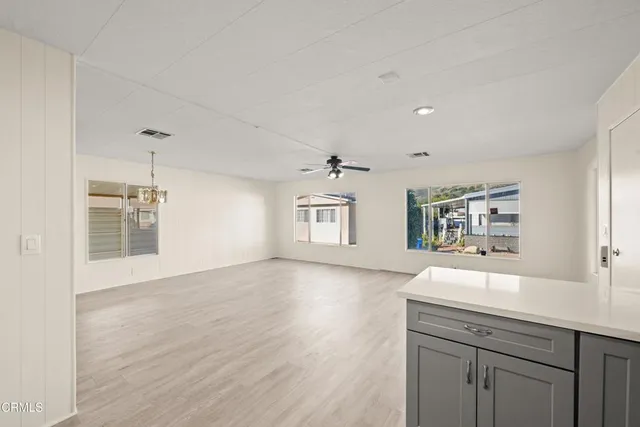 a spacious bathroom with a sink a vanity and a large mirror