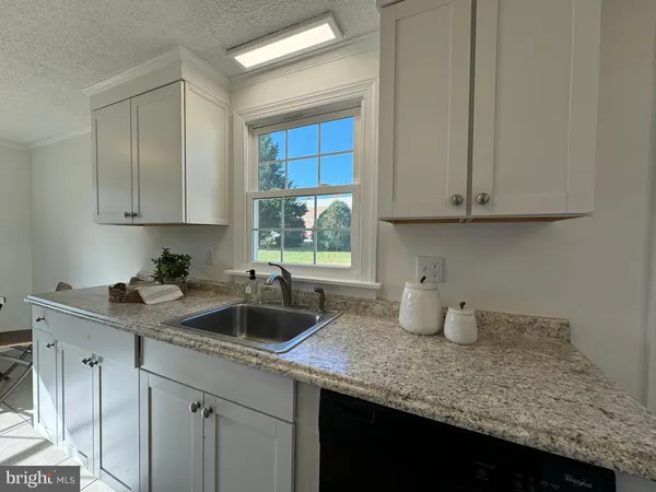 a kitchen with sink and cabinets