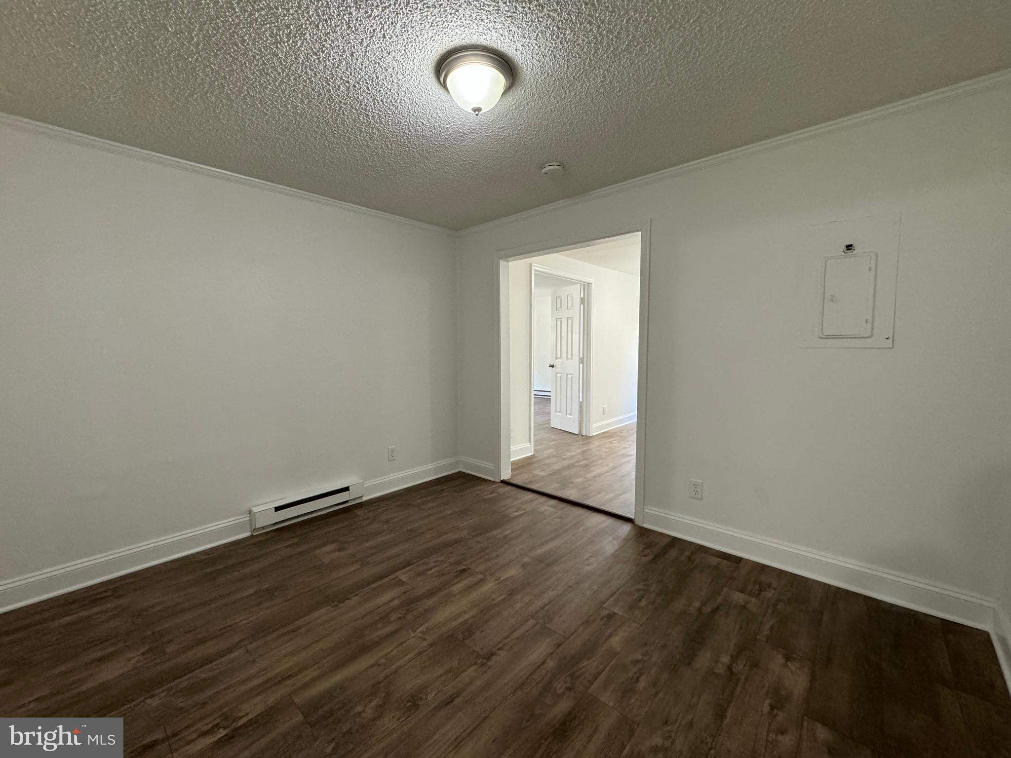 1581 Skinners Turn Road Owings, MD 20736 - Photo 24 of 37 an empty room with wooden floor and natural light