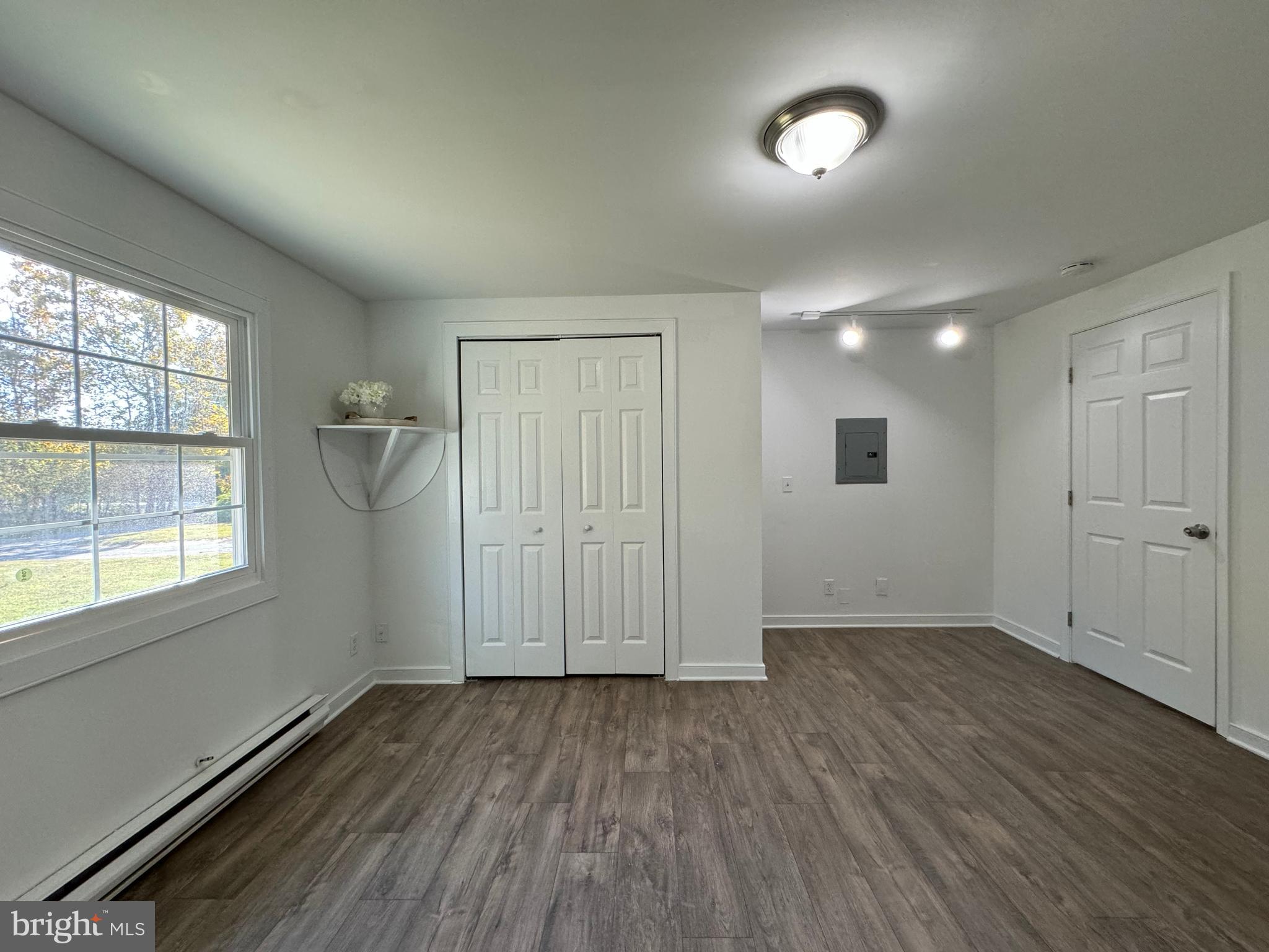 1581 Skinners Turn Road Owings, MD 20736 - Photo 26 of 37 an empty room with wooden floor and windows