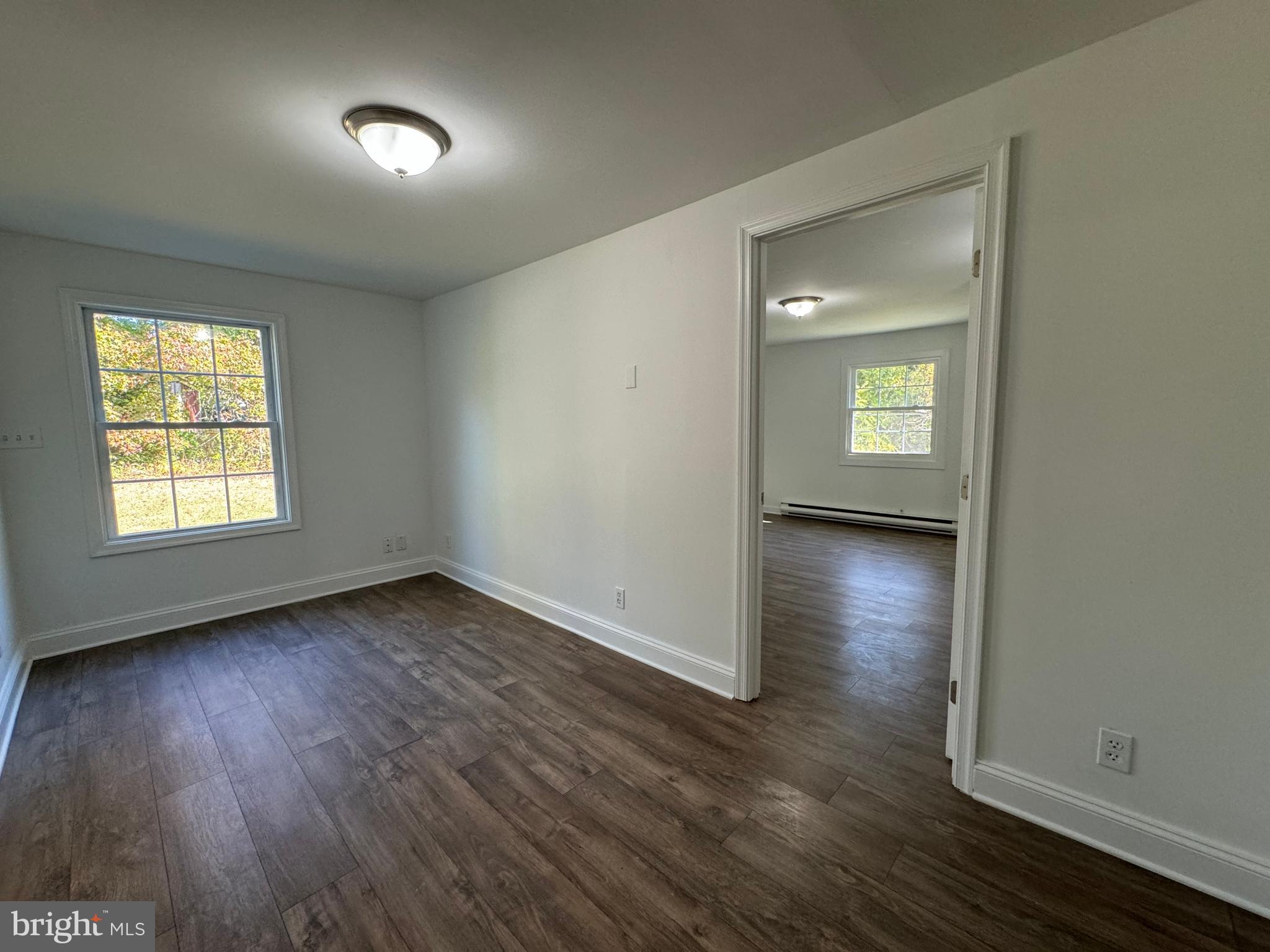 1581 Skinners Turn Road Owings, MD 20736 - Photo 27 of 37 an empty room with wooden floor and a window