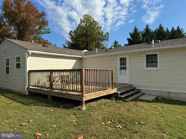 a view of a backyard with a deck and a garden