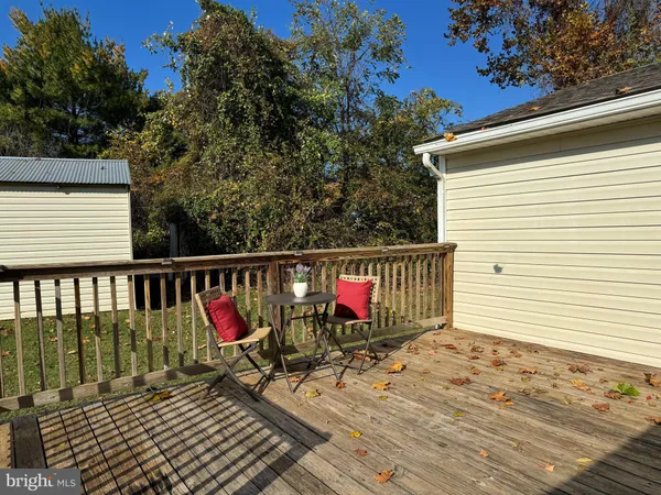 a view of a balcony with wooden floor and fence