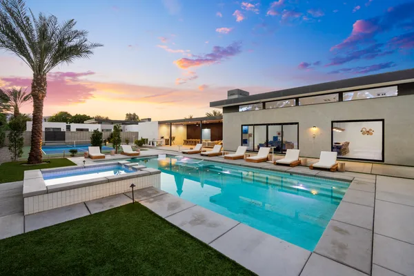 a view of a swimming pool with outdoor seating