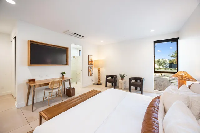 a bedroom with a bed and a lamp