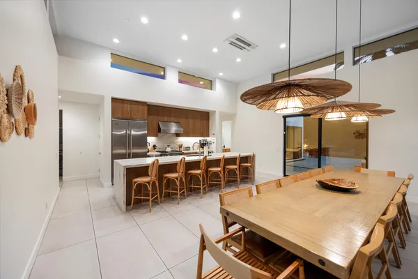 a swimming pool table and chairs in patio