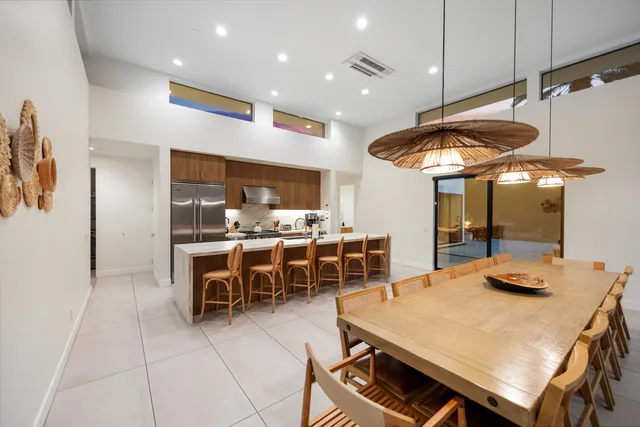 a swimming pool table and chairs in patio