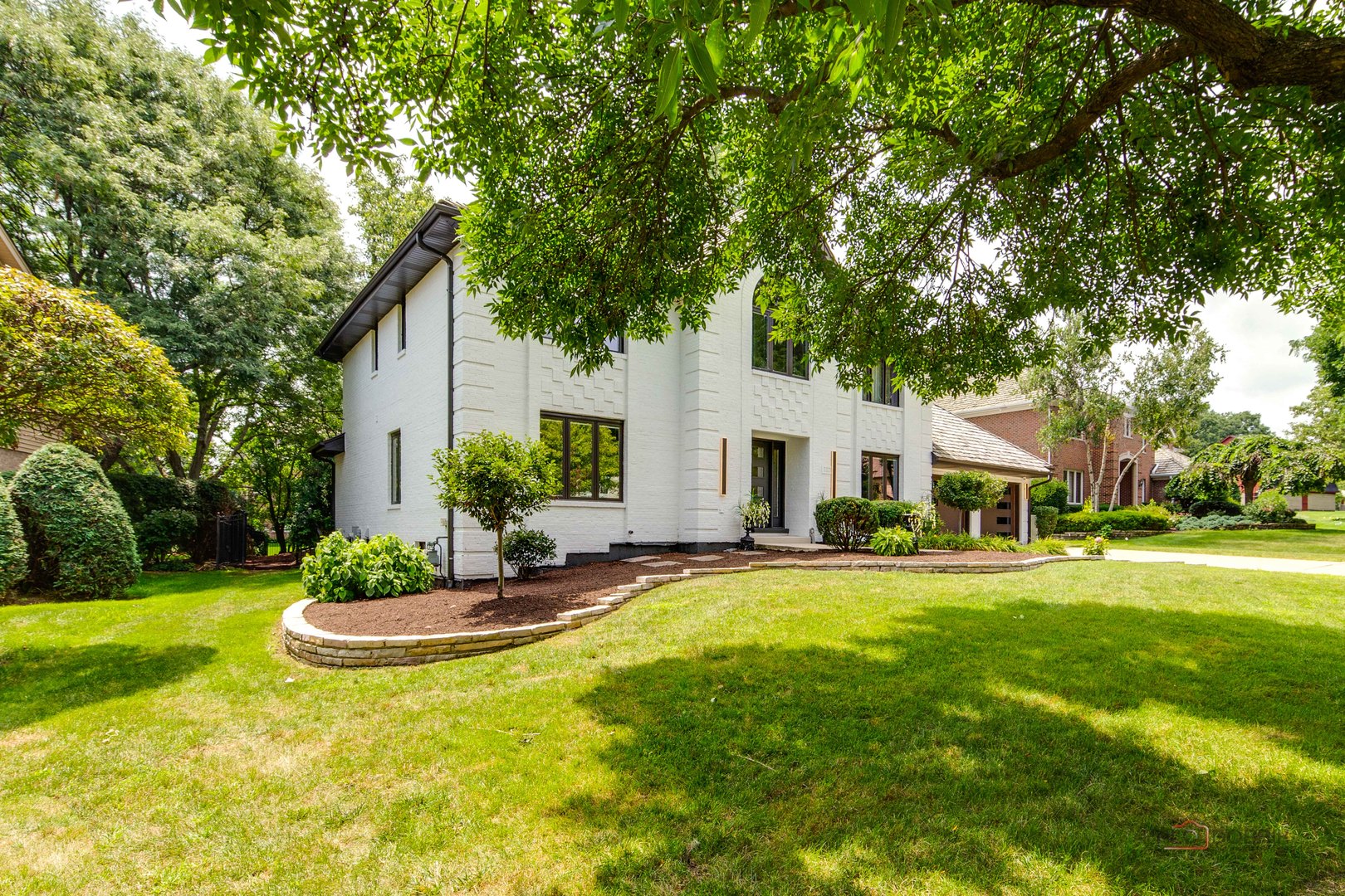 2221 Donegal Drive Darien, IL 60561 - Photo 1 of 62 a view of a white house in a big yard with palm trees