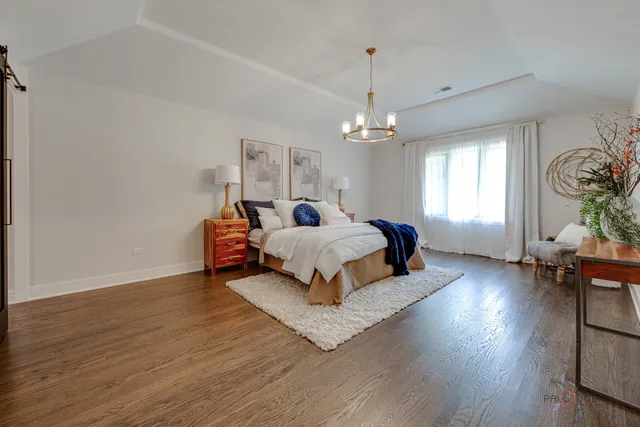 a view of a patio with couches and a table and chairs under an umbrella