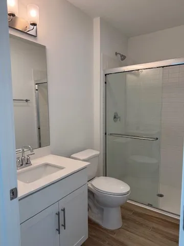 a bathroom with a shower a toilet and sink