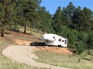 2071 Al Gulch Road Jefferson, CO 80456 - Photo 1 of 25 a white house with a outdoor space