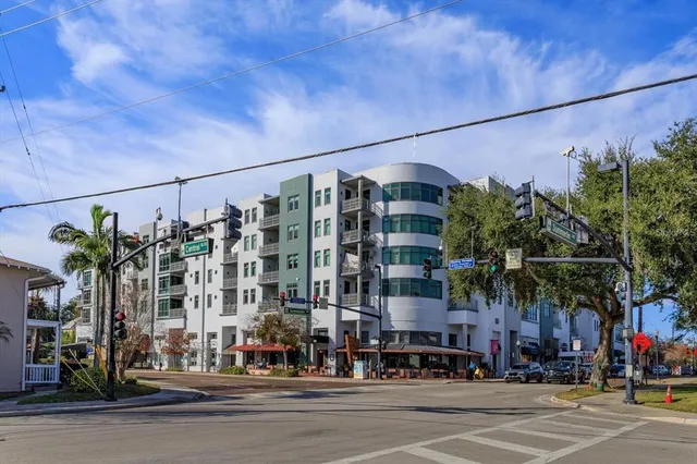 a view of a tall building next to a road