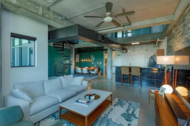 a living room with furniture a table and chairs