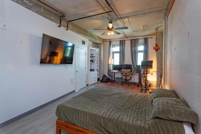 a bed room with a bed and a television