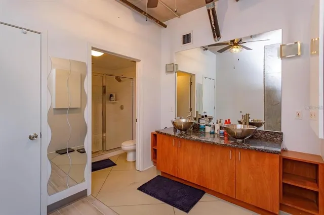 a bathroom with a double vanity sink mirror and shower