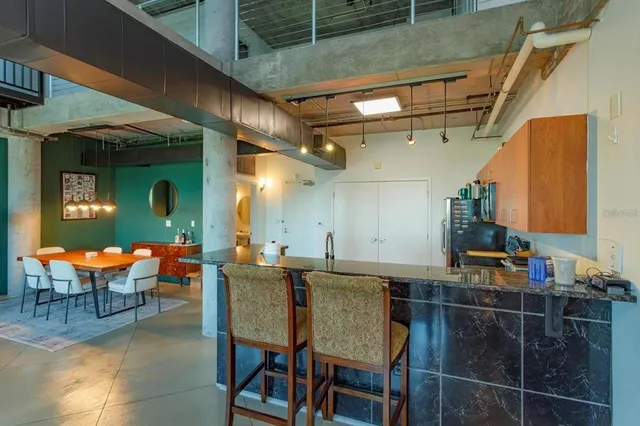a view of a chairs and table in the balcony