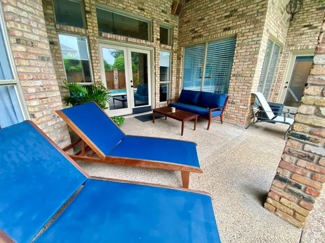 a view of a patio with table and chairs with wooden floor and fence