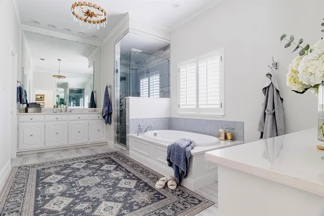 a bedroom with a bed and a mirror on the dresser