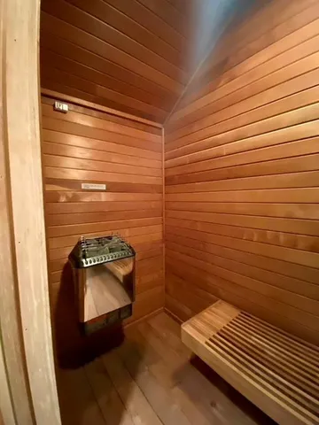 a view of wooden floor and bench in a bathroom