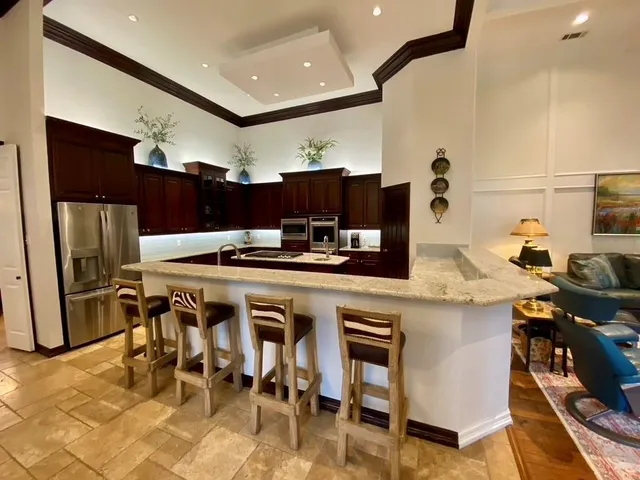 a kitchen with stainless steel appliances kitchen island granite countertop a sink and cabinets