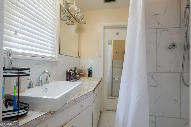 a bathroom with a sink a bathtub and a shower