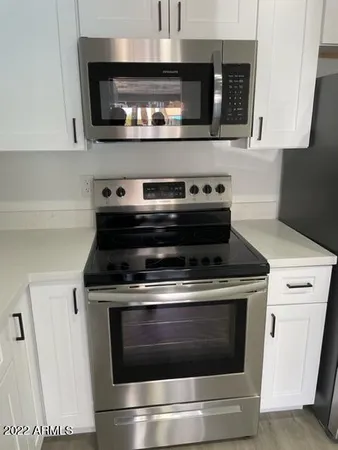 a stove top oven sitting inside of a kitchen