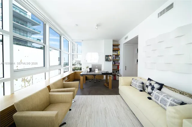 a living room with furniture and a large window