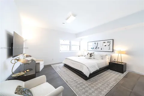 a bedroom with a bed and a couch