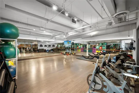 a front view of a house with a garden and trees