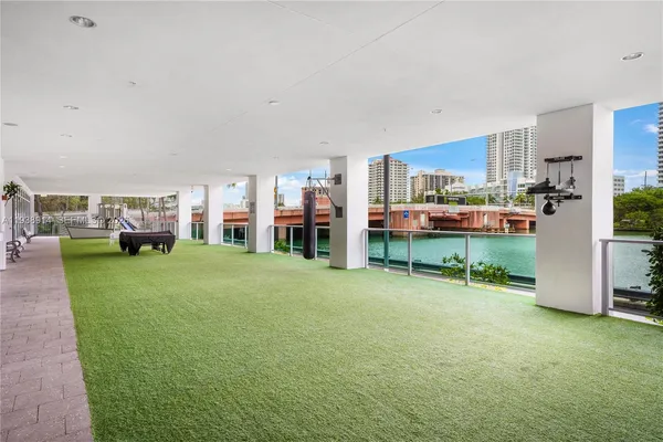 a front view of a house with a garden and trees