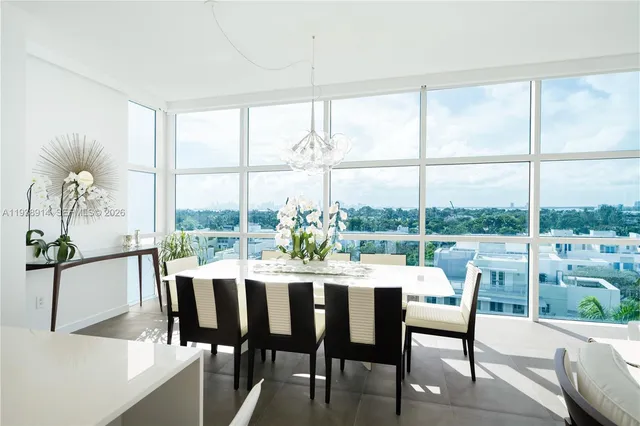 a dining room with furniture a chandelier and wooden floor