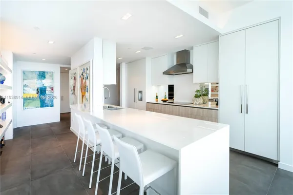 a kitchen with stainless steel appliances a table and chairs