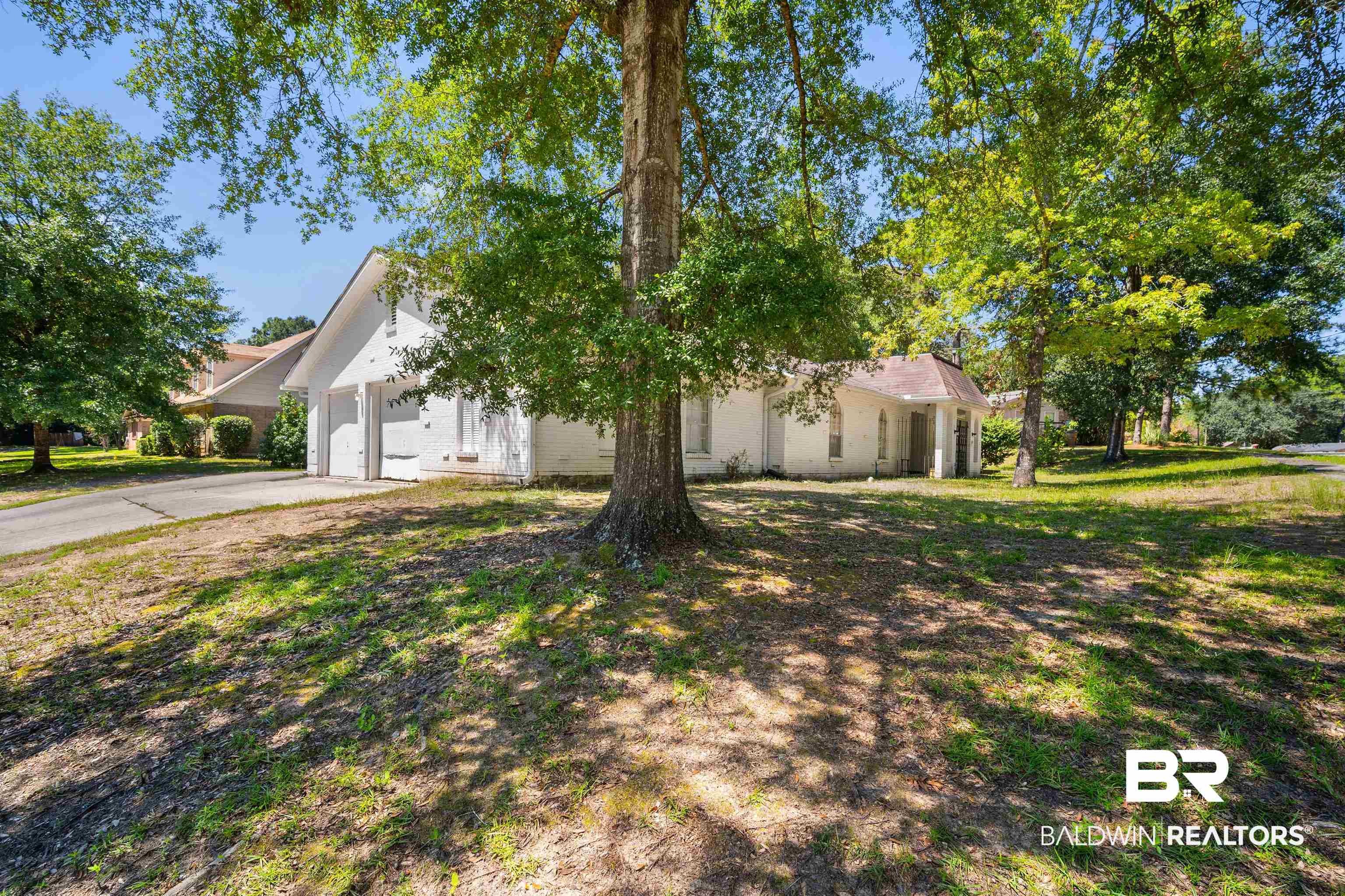 5559 Woodside Drive North Mobile, AL 36608 - Photo 26 of 28 View of front facade with concrete driveway, a front lawn, and a garage