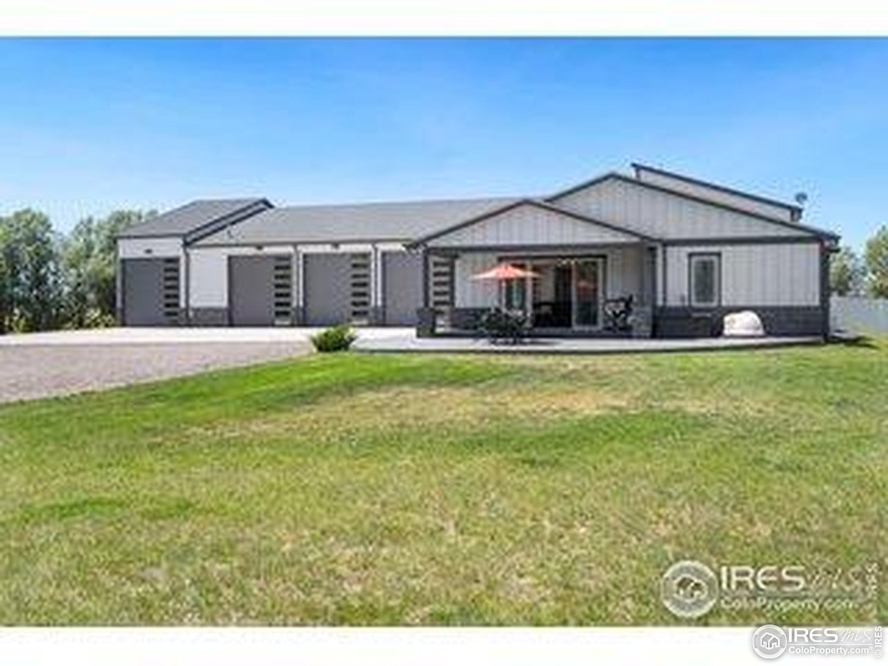 3482 Southeast Frontage Road Fort Collins, CO 80525 - Photo 46 of 47 a front view of a house with a yard and garage