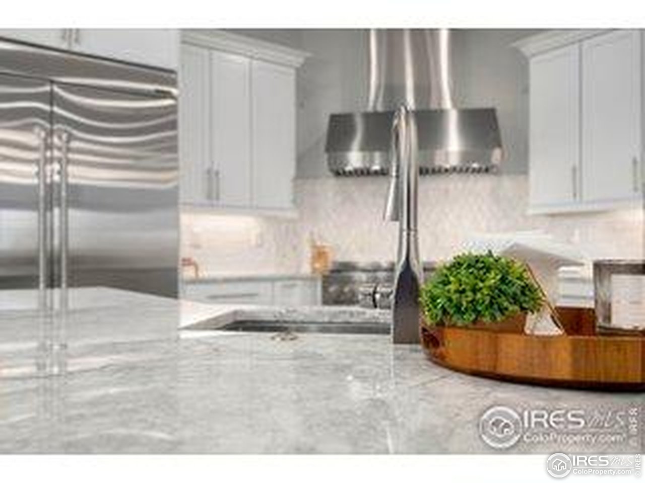 3482 Southeast Frontage Road Fort Collins, CO 80525 - Photo 6 of 47 a kitchen with kitchen island granite countertop a refrigerator and a sink