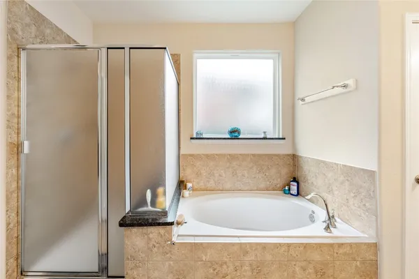 a bathroom with a bathtub and a shower
