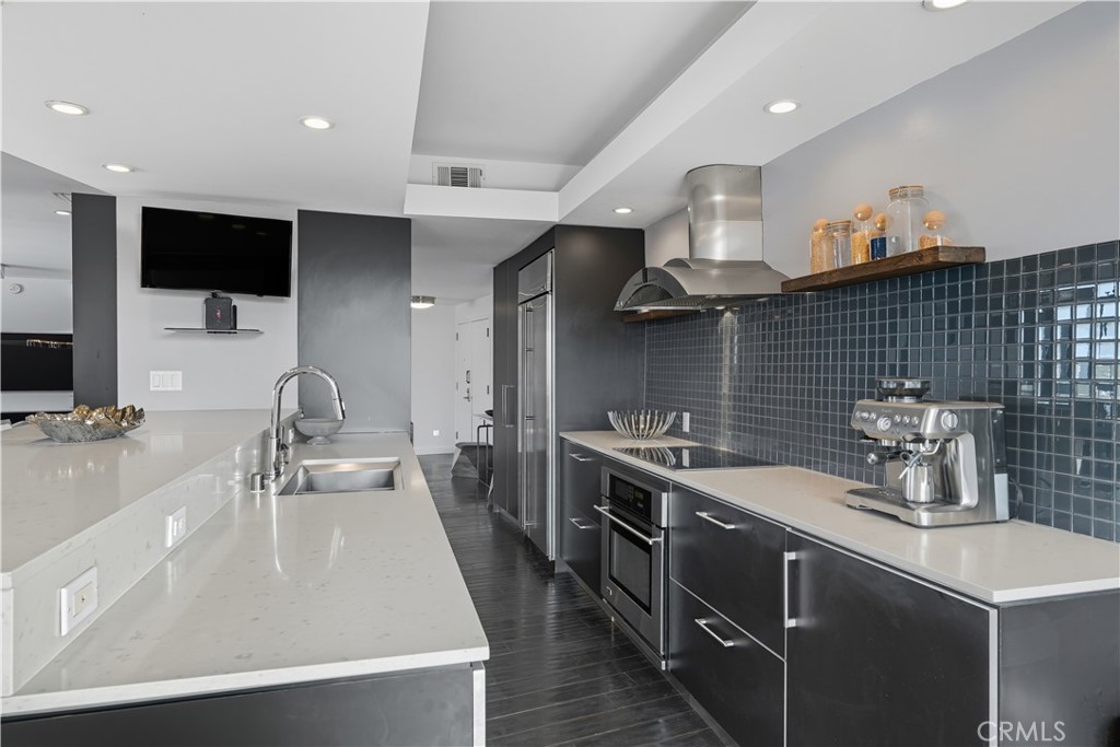 7250 Franklin Avenue, Unit 1203 Los Angeles, CA 90046 - Photo 14 of 37 a kitchen with stainless steel appliances a sink a stove and a wooden floors