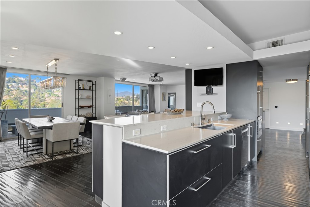 7250 Franklin Avenue, Unit 1203 Los Angeles, CA 90046 - Photo 15 of 37 a large kitchen with a large counter top space a sink stainless steel appliances and cabinets