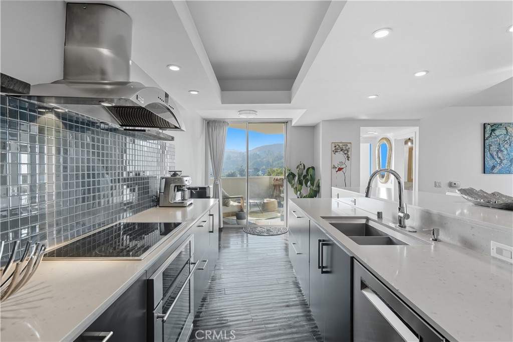 7250 Franklin Avenue, Unit 1203 Los Angeles, CA 90046 - Photo 16 of 37 a kitchen with stainless steel appliances granite countertop a sink and a stove