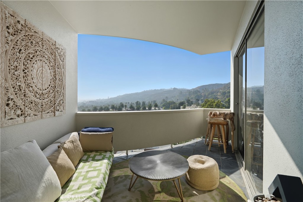 7250 Franklin Avenue, Unit 1203 Los Angeles, CA 90046 - Photo 17 of 37 a view of a balcony with table and chairs