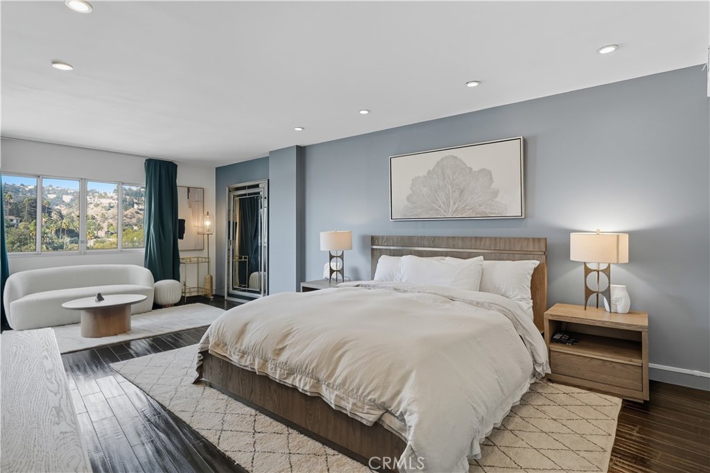7250 Franklin Avenue, Unit 1203 Los Angeles, CA 90046 - Photo 20 of 37 a spacious bedroom with a large bed and a couch