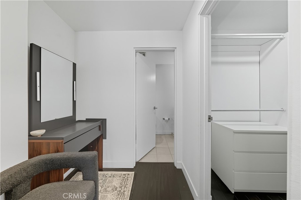 7250 Franklin Avenue, Unit 1203 Los Angeles, CA 90046 - Photo 23 of 37 a hallway with a couch and a dresser with wooden floor