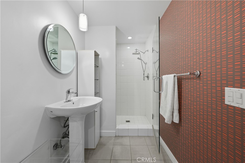 7250 Franklin Avenue, Unit 1203 Los Angeles, CA 90046 - Photo 24 of 37 a bathroom with a sink a toilet and a mirror