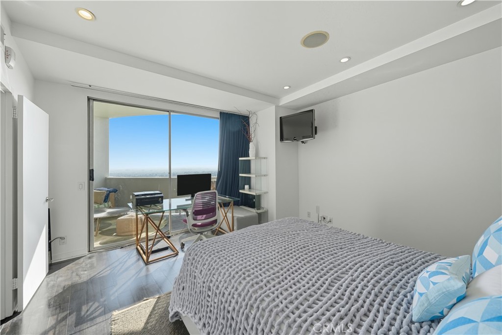 7250 Franklin Avenue, Unit 1203 Los Angeles, CA 90046 - Photo 26 of 37 a bedroom with a bed a table and chair