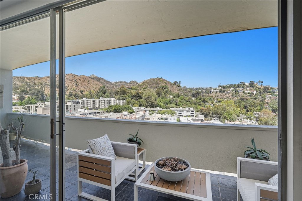 7250 Franklin Avenue, Unit 1203 Los Angeles, CA 90046 - Photo 4 of 37 a view of a balcony with furniture and a potted plant