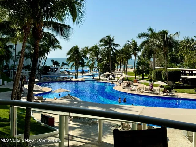 a view of a swimming pool with chairs
