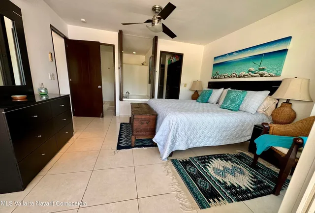 a bedroom with a bed and a dresser