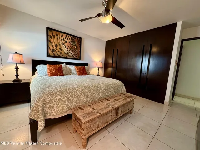 a bed sitting in a bedroom next to a lamp