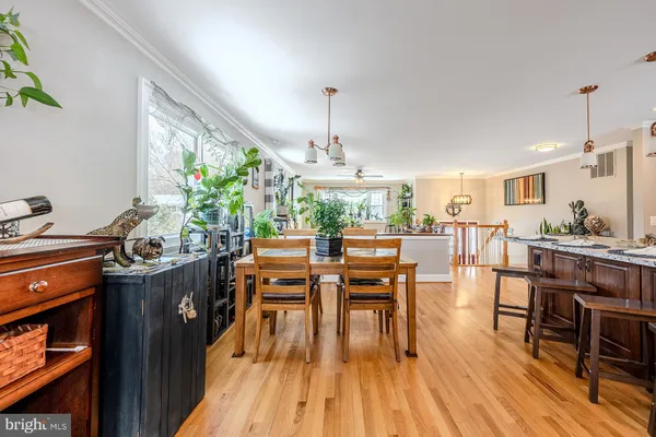 a dining room with furniture and wooden floor