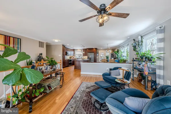 a living room with furniture gym equipment and a chandelier